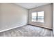 Bedroom features gray carpet and a large window providing natural light and a view at 335 Melody Ne Ln, Cartersville, GA 30121