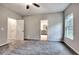 Bright bedroom featuring neutral walls, gray carpet, a ceiling fan and ensuite bathroom access at 335 Melody Ne Ln, Cartersville, GA 30121