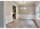 Elegant dining room with wood floors, stylish lighting, and access to the kitchen, perfect for entertaining guests at 335 Melody Ne Ln, Cartersville, GA 30121