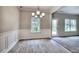 Bright dining room featuring hardwood floors, wainscoting detail, and a modern chandelier at 335 Melody Ne Ln, Cartersville, GA 30121