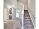 Inviting foyer with plush gray carpeting leading to an open floor plan and staircase with white banister at 335 Melody Ne Ln, Cartersville, GA 30121