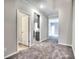 Open-concept foyer showcasing plush gray carpets and clean lines, offering seamless transitions to the rest of the home at 335 Melody Ne Ln, Cartersville, GA 30121