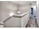 Upstairs hallway with plush gray carpet, chandelier, and a painted white handrail at 335 Melody Ne Ln, Cartersville, GA 30121