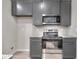 Close up of a kitchen, featuring gray cabinets, stainless steel appliances, and granite countertops at 335 Melody Ne Ln, Cartersville, GA 30121