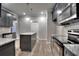 Well-lit kitchen featuring gray cabinets, granite countertops, stainless steel appliances, and a central island at 335 Melody Ne Ln, Cartersville, GA 30121