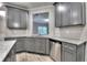 Kitchen with gray cabinets, granite countertops, stainless steel dishwasher and sink overlooking the backyard at 335 Melody Ne Ln, Cartersville, GA 30121