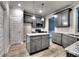 Spacious kitchen featuring gray cabinets, granite countertops, an island, and stainless steel appliances at 335 Melody Ne Ln, Cartersville, GA 30121