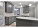 Bright kitchen boasts gray cabinets, granite countertops, and an island for meal preparation and extra storage at 335 Melody Ne Ln, Cartersville, GA 30121