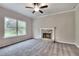 Bright living room with a stone fireplace and large windows, offering a comfortable space for relaxation and entertainment at 335 Melody Ne Ln, Cartersville, GA 30121