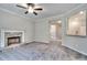Cozy living room featuring a stone fireplace, large windows, and neutral tones, creating a warm and inviting atmosphere at 335 Melody Ne Ln, Cartersville, GA 30121