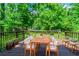 Outdoor deck perfect for dining, with lush green surroundings, seating for six, and potted plants for ambiance at 4078 Bouldercrest Rd, Ellenwood, GA 30294