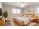 Comfortable bedroom with a wooden bed frame, two windows, and side tables with lamps for a serene retreat at 4078 Bouldercrest Rd, Ellenwood, GA 30294