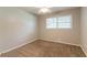 Bedroom with carpet, neutral walls, a ceiling fan, and a window for natural light at 4078 Bouldercrest Rd, Ellenwood, GA 30294