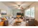 Cozy living room with hardwood floors, ceiling fan, lots of light, and comfortable seating arrangement at 4078 Bouldercrest Rd, Ellenwood, GA 30294