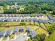 Community of residential homes with green lawns and mature trees, as seen from above at 4720 Dufour Dr, Lilburn, GA 30047