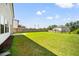Expansive backyard featuring lush green grass and a privacy fence, ideal for outdoor activities at 4720 Dufour Dr, Lilburn, GA 30047