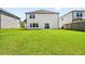 Well-maintained backyard showing ample lawn space and the rear exterior of the white two-story home at 4720 Dufour Dr, Lilburn, GA 30047