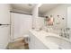 Bright bathroom featuring a double sink vanity, modern fixtures, and a patterned tile floor at 4720 Dufour Dr, Lilburn, GA 30047