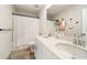 Bathroom with a double sink vanity and a shower with a patterned curtain at 4720 Dufour Dr, Lilburn, GA 30047