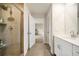 Well-lit bathroom featuring a walk-in shower and a modern vanity with a white countertop and shaker cabinets at 4720 Dufour Dr, Lilburn, GA 30047