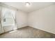 Cozy bedroom with soft carpet and a bright window dressed with sheer curtains at 4720 Dufour Dr, Lilburn, GA 30047