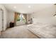Spacious bedroom with large window, ensuite bath, and neutral carpet at 4720 Dufour Dr, Lilburn, GA 30047