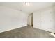 Bedroom with neutral carpet, white walls, with an entry to an adjoining room at 4720 Dufour Dr, Lilburn, GA 30047