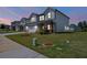 Two-story home with green lawn, showcasing its exterior on a clear evening at 4720 Dufour Dr, Lilburn, GA 30047