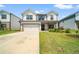 Charming two-story home with a manicured lawn, two-car garage, and welcoming front porch at 4720 Dufour Dr, Lilburn, GA 30047