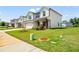 Two-story home with attached garage and lush lawn, showcasing curb appeal at 4720 Dufour Dr, Lilburn, GA 30047