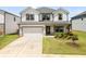 Charming two-story home with a two-car garage and well-maintained front lawn at 4720 Dufour Dr, Lilburn, GA 30047