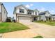 Two-story home with a two-car garage and a well-maintained lawn on a sunny day at 4720 Dufour Dr, Lilburn, GA 30047