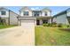 Charming two-story home featuring a two-car garage, lush green lawn, and inviting front entrance at 4720 Dufour Dr, Lilburn, GA 30047