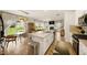 Open kitchen with a large island, white cabinets, stainless steel appliances, and an adjacent living area at 4720 Dufour Dr, Lilburn, GA 30047