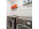 Laundry room with new washer and dryer plus storage shelf at 4720 Dufour Dr, Lilburn, GA 30047