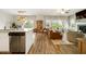 Open-concept living space with wood floors, modern kitchen, and a cozy living area with ample natural light at 4720 Dufour Dr, Lilburn, GA 30047