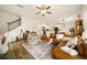Cozy living room showcases a brown leather sectional, rug, ceiling fan and staircase at 4720 Dufour Dr, Lilburn, GA 30047
