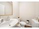 Modern powder room features a white vanity, sink, faucet, and toilet at 4720 Dufour Dr, Lilburn, GA 30047