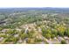 Expansive aerial view of a community nestled amidst lush greenery and a serene lake nearby at 2657 John Petree Rd, Powder Springs, GA 30127