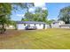 A white home with a gray deck and a spacious, fenced backyard with an expansive lawn at 2657 John Petree Rd, Powder Springs, GA 30127