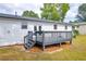 Back of house with patio and stairs to backyard at 2657 John Petree Rd, Powder Springs, GA 30127