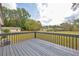 Spacious backyard view from the deck, showcasing a large grassy area, mature trees, and a peaceful setting at 2657 John Petree Rd, Powder Springs, GA 30127