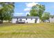 View of the house from the backyard showing the deck, and a large grassy area at 2657 John Petree Rd, Powder Springs, GA 30127