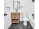 Elegant bathroom with a modern vanity, dark hardware, and stylish hexagon tile flooring at 2657 John Petree Rd, Powder Springs, GA 30127