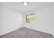 Bright bedroom with plush carpet, a window with blinds, and a neutral color palette at 2657 John Petree Rd, Powder Springs, GA 30127