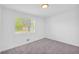 Bright bedroom featuring carpet, white paint, and natural light at 2657 John Petree Rd, Powder Springs, GA 30127