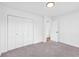 Bedroom featuring carpet, white paint, and double door closet at 2657 John Petree Rd, Powder Springs, GA 30127