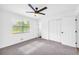 Bedroom featuring carpet, white paint, ceiling fan and double door closet at 2657 John Petree Rd, Powder Springs, GA 30127