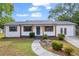 Charming home featuring a manicured lawn, wood accents, and a stone walkway leading to the front door at 2657 John Petree Rd, Powder Springs, GA 30127