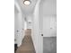 Bright hallway with hardwood floors leading to rooms with neutral walls and white doors at 2657 John Petree Rd, Powder Springs, GA 30127
